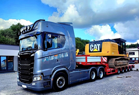 International CAT construction machinery transport on a lowbed trailer in Europe